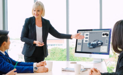 Team discussing 2025 automotive market research with EV trends, luxury preferences, and consumer insights on a screen