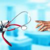 A robotic hand holding a stethoscope and reaching toward a human doctor’s hand, symbolizing the collaboration between AI technology and human empathy in healthcare research.